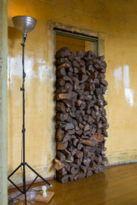 David Ireland, 500 Capp Street (interior view with logs in doorway), 1987. Wood, 80 x 33 x 15 inches. Remade for the exhibition Amulet or He calls it chaos, 2019.